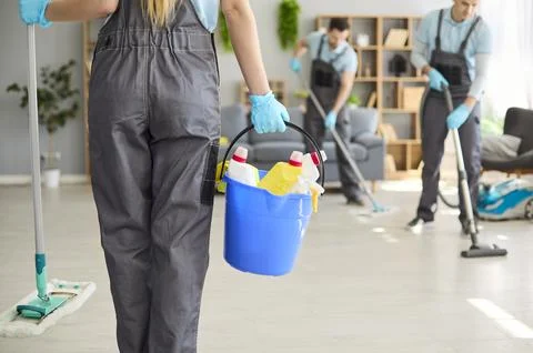 Professional cleaning team sanitizing interior with bucket, gloves, mop, vacuum Stock Photos