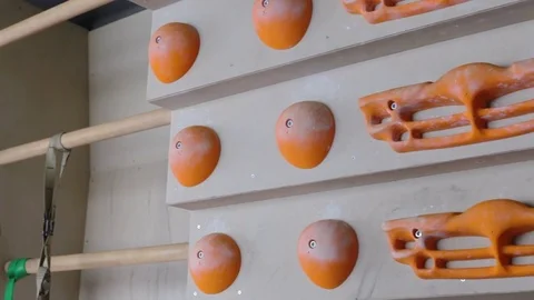 Professional climber performs exercises on training bouldering wall. 1080p video Video stock 77803372