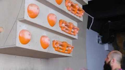 Professional climber performs exercises on training bouldering wall. 1080p video Video stock 77803485