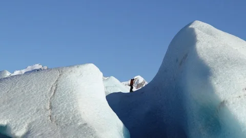 Professional climber walking with crampons on huge frozen formation, Alaska Stock Footage 129111792