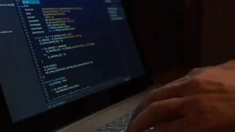 A professional Coder Writes a Script on a Laptop. The Developer Encodes. The Pro Vidéo 132634514