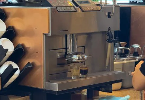 Professional coffee machine preparing espresso shots. Beverage preparation, h Foto stock