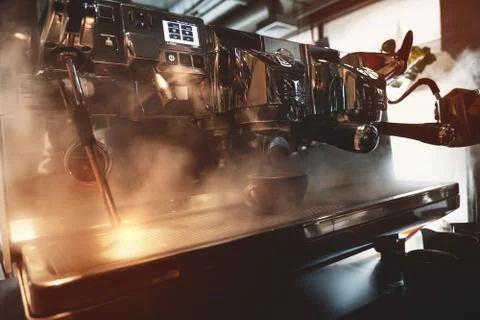 Professional coffee machine in steam while barista making coffee drink whipping Stock Photos