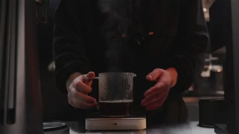 Professional coffee roaster brewing hand brew to check roast quality Stock Footage 334732447