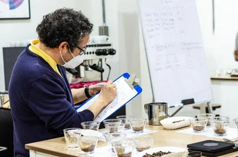 Professional coffee taster testing new smells and flavors. Stock Photos