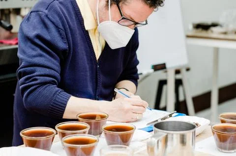 Professional coffee taster testing new smells and flavors. Stock Photos