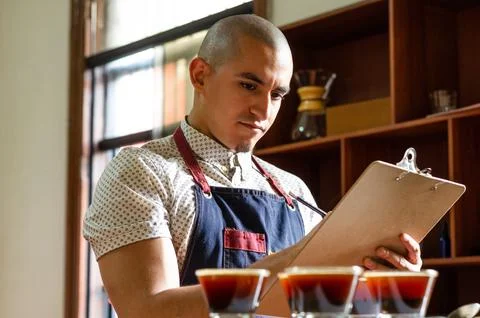 Professional coffee taster testing new smells and flavors. Stock Photos