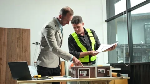 Professional collaboration in architecture. Two engineers work on construct.. Stock Footage 313705679
