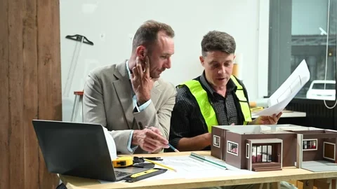 Professional collaboration in architecture. Two engineers work on construct.. Stock Footage 313705689