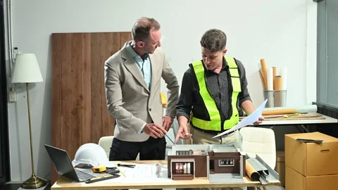Professional collaboration in architecture. Two engineers work on construct.. Stock Footage 313705691