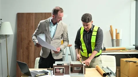 Professional collaboration in architecture. Two engineers work on construct.. Stock Footage 313705714