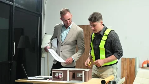 Professional collaboration in architecture. Two engineers work on construct.. Stock Footage 313705723