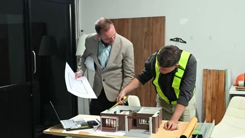 Professional collaboration in architecture. Two engineers work on construct.. Stock Footage 313705727