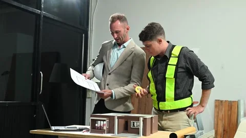 Professional collaboration in architecture. Two engineers work on construct.. Stock Footage 313705731