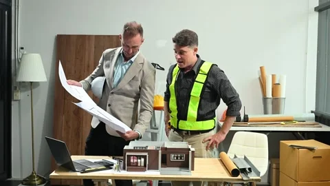 Professional collaboration in architecture. Two engineers work on construct.. Stock Footage 313705767