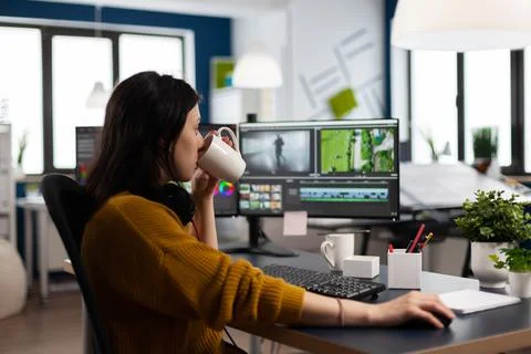 Professional colorist working in video footage using post production software Stock Photos