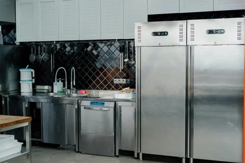 Professional commercial empty clean modern kitchen in restaurant or cafe Metal Stock Photos