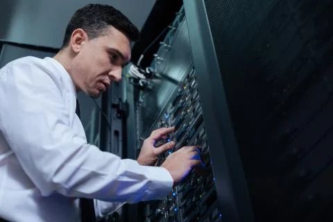 Professional computer engineer looking at the data server Stock Photos
