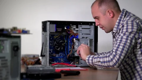 Professional computer service specialist man remove and examine ram memory Stock Footage 73523892