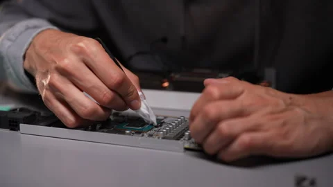 Professional computer technician male cleaning CPU of desktop computer Stock Footage 284873486