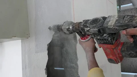 Professional Concrete Wall Drilling Using Electric Hammer Drill Stock Footage 325365544