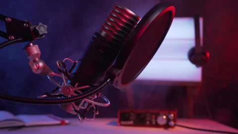 Professional Condenser Microphone Setup with Pop Filter in Studio Lighting Video stock 329680861