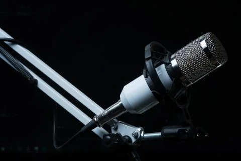 Professional condenser studio microphone on the black background Stock Photos