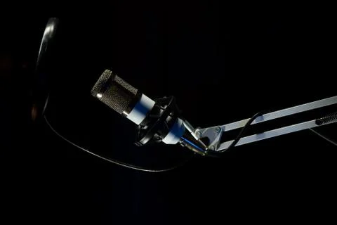 Professional condenser studio microphone on the black background Stock Photos