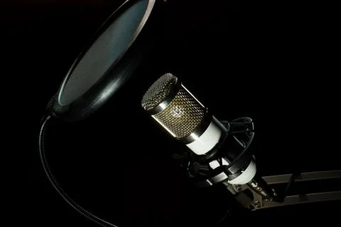 Professional condenser studio microphone on the black background Stock Photos