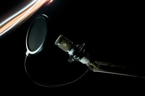 Professional condenser studio microphone on the black background and freezeli Stock Photos
