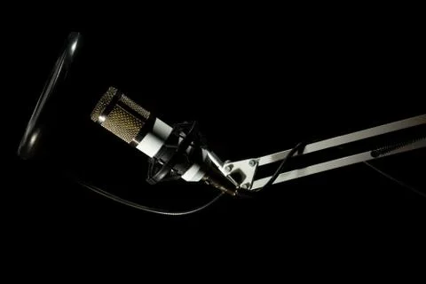 Professional condenser studio microphone on the black background Stock Photos