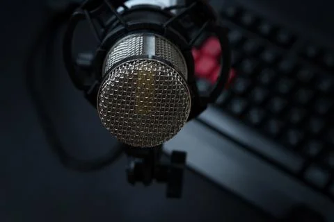 Professional condenser studio microphone over the keyboard Stock Photos