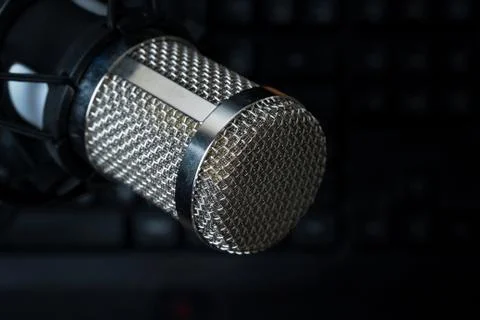 Professional condenser studio microphone over the keyboard Stock Photos