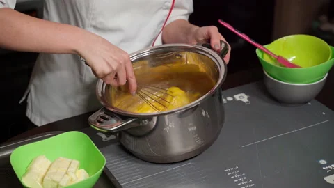 A professional confectioner chef kneads a christmas cake dough with a whisk Stock Footage 166316306