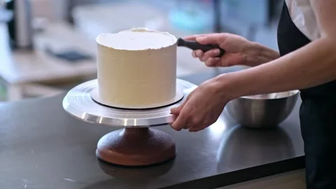 Professional confectioner finishing pattern on white mastic of cake with knife Stock Footage 244667922