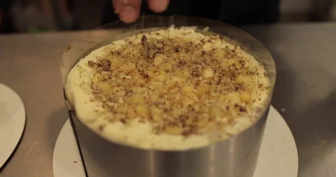 A professional confectioner prepares a cake with nuts, close-up. Stock Footage 252669724