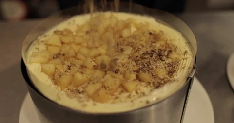 A professional confectioner prepares a cake with nuts, close-up. Stock Footage 252669835