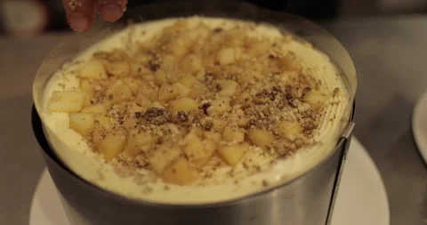 A professional confectioner prepares a cake with nuts, close-up. Stock Footage 252669886