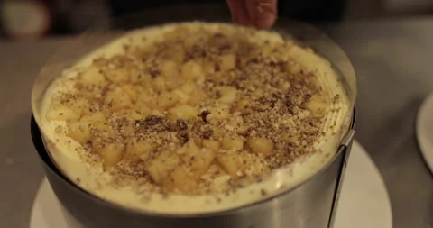 A professional confectioner prepares a cake with nuts, close-up. Stock Footage 252669971