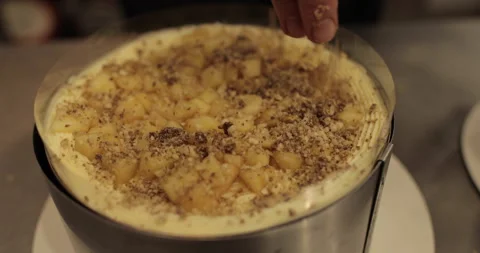 A professional confectioner prepares a cake with nuts, close-up. Stock Footage 252669985