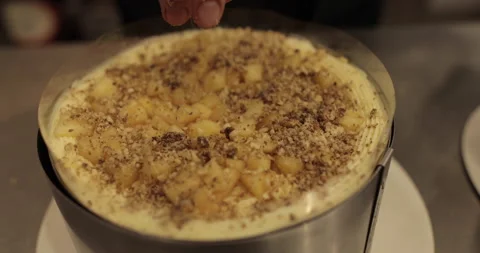 A professional confectioner prepares a cake with nuts, close-up. Stock Footage 252670025