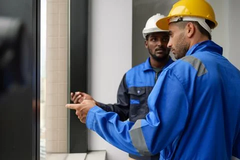 Professional construction engineers team using blueprint of project plan Stock Photos