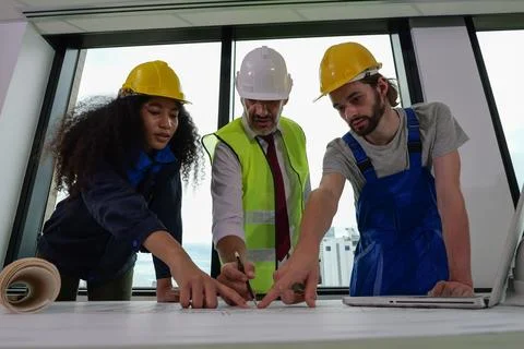 Professional construction engineers team using blueprint of project plan 스톡 사진