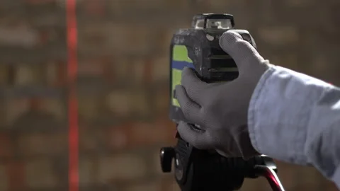 Professional construction laser level tool with red beam on building site Stock Footage 330058841