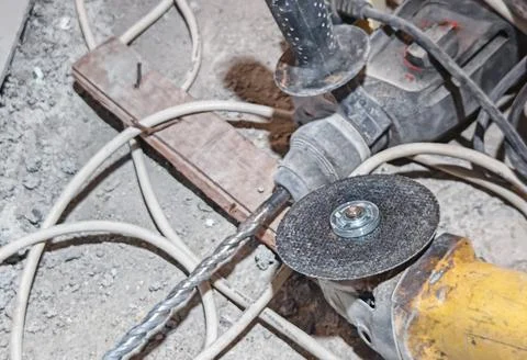 Professional Construction Tools and Angle Grinder on Workshop Floor Stock Photos