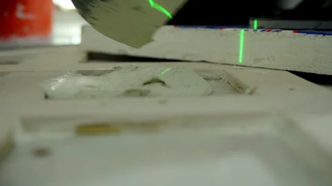 Professional construction worker applies thick layer of adhesive to the floor to Stock Footage 310630296