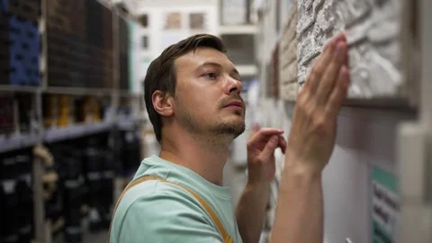 Professional construction worker carefully examining white decorative brick Video stock 310904306