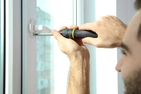 Professional construction worker installing window indoors, closeup Stock Photos