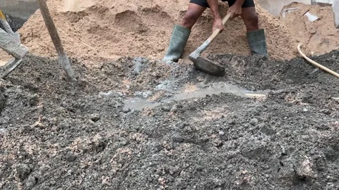 Professional construction worker mixes wet grey cemen Stock Footage 308915297