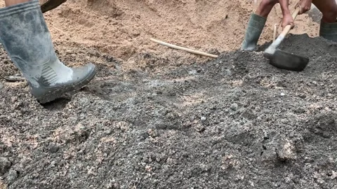 Professional construction worker mixes wet grey cemen Stock Footage 308915412